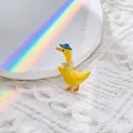 Cute yellow duck brooch with blue hat and rhinestones on white knitted background - Yellow Duck