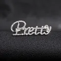 Macro shot of silver-tone Pretty letter brooch with sparkling rhinestones and pear-cut gem - Silver Pretty Style