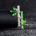 Macro shot of bamboo brooch with green marquise crystals and white rhinestones - Bamboo Style