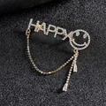 Broche dorée de luxe avec lettres HAPPY, visage souriant en cristal et pompon - Or Visage Souriant (HAPPY)