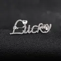 Macro shot of silver 'Lucky' letter brooch with heart and teardrop shaped rhinestones - Silver Lucky Style