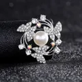 Detailed view of silver wreath brooch with white pearl, butterflies and zircon accents - Silver Butterfly