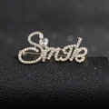 Macro detail of Smile alphabet brooch with sparkling heart crystal and rhinestones - Golden Smile Style