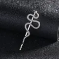 Detail of silver snake hair clip featuring scale texture and green crystal eyes - Silver