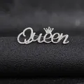 Close-up of a silver Queen letter brooch with rhinestones and a small crown detail - Silver Queen Style