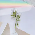 Elegant double white rose hair clip with green leaves and pearl accents on pastel background - White Rose Brooch / White