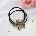 Elegante coletero en forma de estrella con cristales negros y aleación dorada - Estrella De Mar Negra Brillante