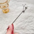 Macro detail of silver plum blossom hair stick with vintage wood grain texture - Retro Silver Branch Shape / Silver Plum Blossom