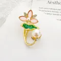 Close-up of alloy lotus flower brooch with pink petals, green enamel leaves, and pearls - Pink Lotus Shape / Pink