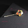Detail view of a 5cm golden maple leaf hair clip with pearls and red rhinestones - Maple Leaf Side Clip