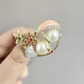 Christmas snowman brooch featuring white pearls, pink enamel moon and golden snowflake accents - XZ148 Pink