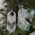 Ethnic style silver bohemian earrings with long tassels hanging on a tree branch - Silver Hollow Tapered Tassel Style (E3037-2)