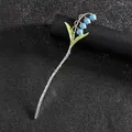 Épingle à cheveux élégante muguet avec fleurs en émail bleu et feuilles vertes sur noir - Bleu