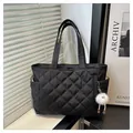 Large black quilted tote bag with diamond stitching and cute white plush ball charm - Black With Pendant