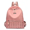 Pink nylon backpack for women featuring silver stud accents and adjustable straps - Pink