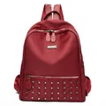Fashionable burgundy nylon backpack for women with silver rivets and dual zipper closure - Red