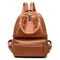 Detail view of brown PU leather backpack with double front zippers and fabric straps - Brown