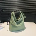 Minimalist light green nylon hobo bag with distinctive black and white rope shoulder strap - Green