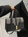 Schicke schwarze Patchwork-Schultertasche mit Webmuster und goldener Schnalle - Schwarz
