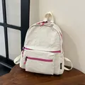 Detail of crinkled white nylon fabric texture and contrasting pink zipper on backpack - Off White