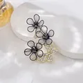 Elegant gold butterfly brooch with black fabric flowers and sparkling rhinestones - Black