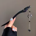 Detail of ebony hair pin featuring hollow carving and tassel with calligraphy bead - Hollow Carved Shunxin Bead Style (Hairpin 3)