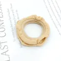 Detailed close-up of beige ruffled fabric hair scrunchie on a decorative book background - Light Khaki Pleated