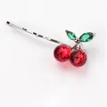 Close-up of elegant crystal cherry hair clip with red and green faceted gemstones - Bobby Pin