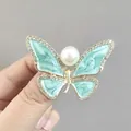Elegant gold butterfly brooch with mint green enamel, white pearls and sparkling rhinestones - Blue