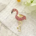 Pink rhinestone flamingo brooch with gold alloy base and polished metal wing detail - Flamingo