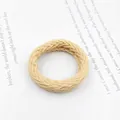Detailed view of the woven beige ruffled hair tie featuring a soft textured braided design - Thick Light Khaki Braid