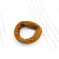 Macro shot of seamless caramel elastic hair tie with spiral woven texture on book - Thick Light Coffee Braid