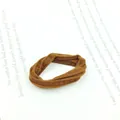 Detailed close-up of a coffee brown elastic hair tie on a white text background - Thin Light Coffee