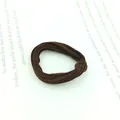 Close-up of a dark coffee brown velvet seamless hair tie on minimalist literary paper - Thin Dark Coffee