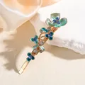 Elegant floral alloy hair clip with blue enamel petals and sparkling rhinestones on silk - Blue