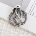 Silver cobra snake brooch with crystals and textured scales on a white fabric background - Antique Silver Wrapped Snake (XZ255)