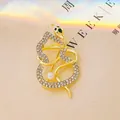 Exquisite gold snake brooch with sparkling crystals, green gemstone eye and white pearl - Gold 4