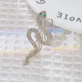 Silver snake brooch with green crystal eyes and clear rhinestones in elegant S-shape - Triple Layer Silver
