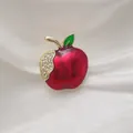 Detail of red enamel apple brooch with sparkling white rhinestones on silk fabric - Rhinestone Apple Style / Red Apple