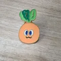 Cute carrot enamel brooch pin with green leaves and orange body on wood background - Expression Carrot Style / Carrot