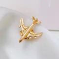 Close-up of golden airplane brooch showing fine metallic details on white satin - Small Gold Airplane Minimalist Style (XZ289)