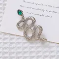 Detalle de broche de serpiente plateado con gema verde gota y textura de escamas - Serpiente de Plata Antigua Vintage