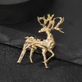 Detail of geometric gold elk brooch with multi-faceted metallic design on black stone - Geometric Deer / Gold