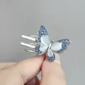 Pinza para el pelo de mariposa plateada con diamantes azules y piedra de luna blanca - Mariposa / Silver Blue And White