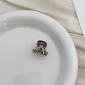 Detailed view of a mini translucent coffee hair claw clip with silver bow design - Champagne Bowknot