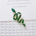 Retro gold snake brooch with a green teardrop gemstone and sparkling star details - Green Snake (XZ305)