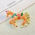 Detailed close-up of orange enamel carousel horse brooch with colorful saddle and rhinestones - Orange Carousel (XZ75-001 Pink)