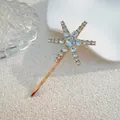 Detailed close-up of a golden hair clip with a rhinestone-studded star on a textured background - Large Star Style (J009-01) / Gold