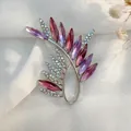 Close-up of elegant wheat ear brooch with purple and pink crystals on white silk - Purple Olive Branch Style