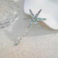 Detail of star-shaped hair clip with light blue crystals on a silver metal base - Large Star Style (J009-01) / Silver